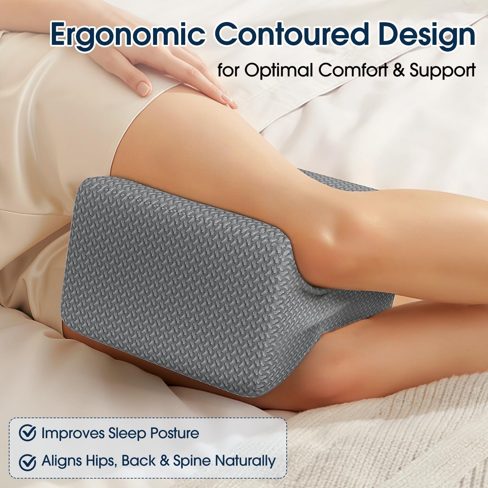 Gray contoured knee and leg pillow placed under the knee on a bed